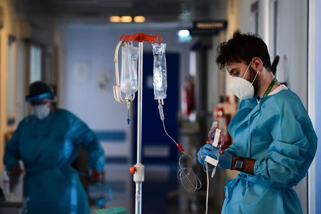 A member of the medical staff wearing a personal protective equipment (PPE) stands in a corridor of the Covid-19 intensive care unit of Cremona hospital, in Cremona, northern Italy, on January 11, 2022. - Italy's Prime Minister put the pressure back on the unvaccinated on January 10, 2022, calling them the cause of 