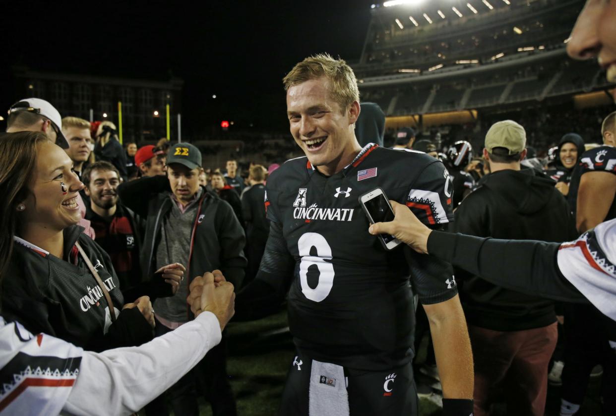 Cincinnati quarterback Hayden Moore (8) is surrounded by fans after defeating Miami 34-23. (AP Photo/Gary Landers)