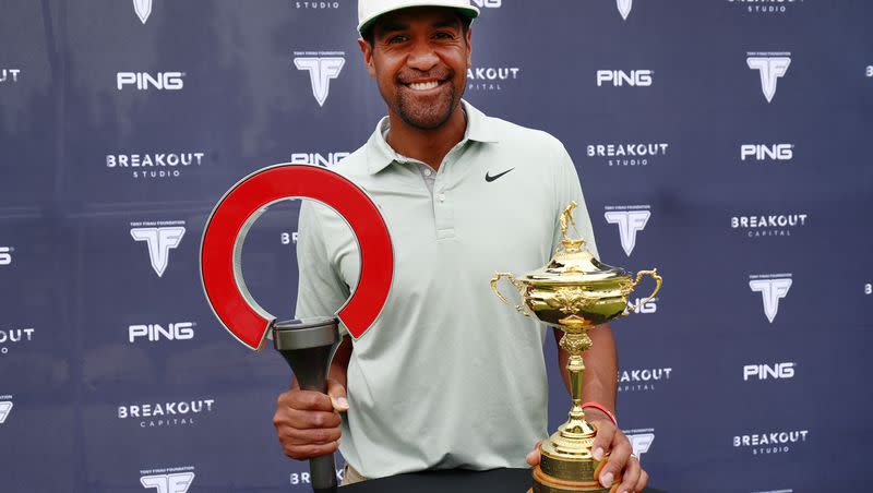 Golfer Tony Finau poses for a photo with the two trophies he won from the 3M Open and the Rocket Mortgage Classic during the Tony Finau Foundation Golf Classic at Oakridge Country Club in Farmington on Monday, Aug. 1, 2022. Finau is ready to play in this weekend’s U.S. Open.