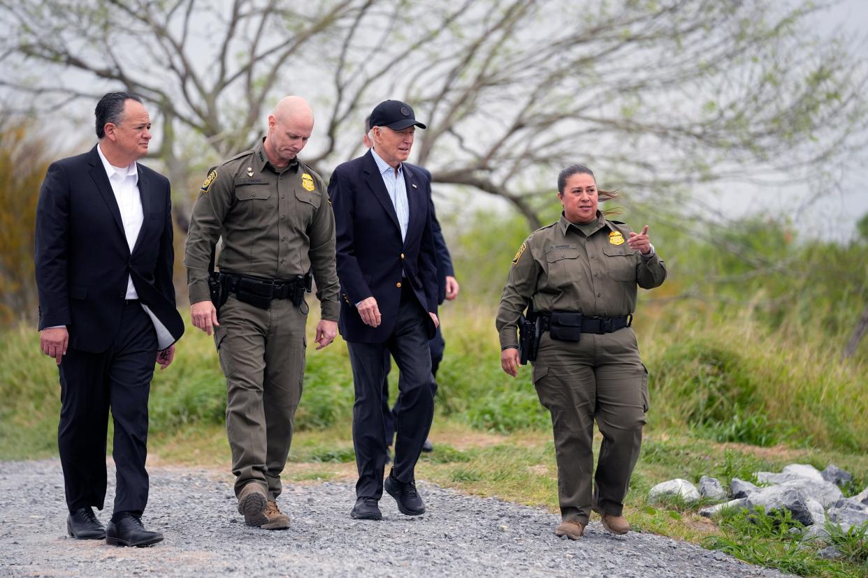 President Joe Biden, second from the right, looks over the southern border on Thursday in Brownsville, Texas. Walking with Biden are from left to right., Peter Flores, deputy commissioner, U.S. Customs and Border Protection, Jason Owens, chief, U.S. Border Patrol and Gloria Chavez, sector chief, U.S. Border Patrol.