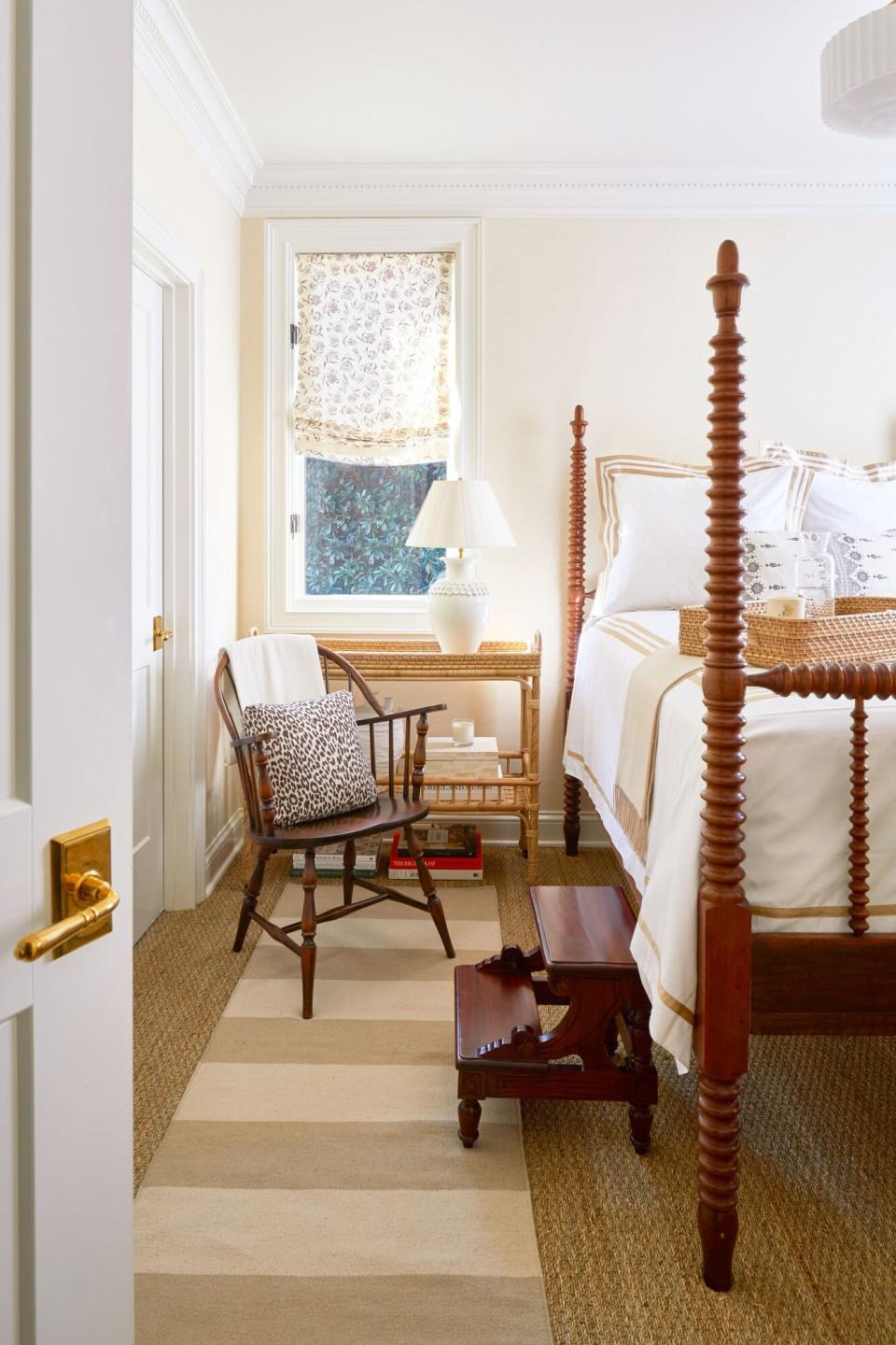 Welcoming guest room with four-poster spool bed and crisp white bedding