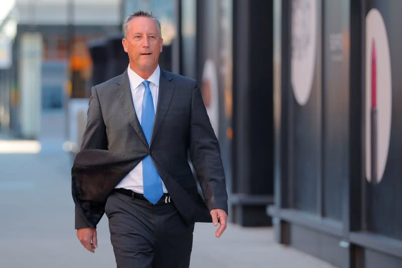 Martin Fox passes the federal courthouse before entering a plea in Boston