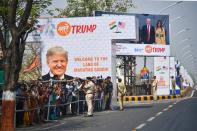 People gather beside a street as a motorcade transporting US President Donald Trump makes its way in Ahmedabad on February 24, 2020. (Photo by Mandel NGAN / AFP) (Photo by MANDEL NGAN/AFP via Getty Images)