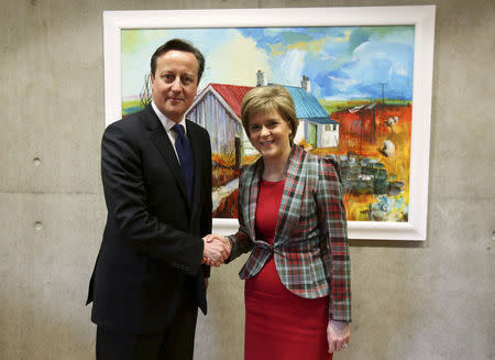 Scotland's First Minister Nicola Sturgeon shakes hands with Britain's Prime Minister David Cameron in her office at the Scottish Parliament in Edinburgh, January 22, 2015. REUTERS/POOL/Andrew Milligan