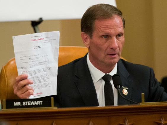 Rep. Chris Stewart, R-Utah, holds up the transcript summary of the call between Trump and Zelenskiy (Alex Brandon/AP)