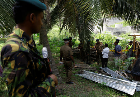 Police investigators work at the site of a blast behind the magistrates court in the town of Pugoda, 40 km (25 miles) east of the capital Colombo, Sri Lanka April 25, 2019. REUTERS/Thomas Peter