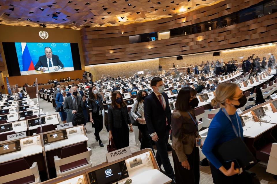 Ambassadors and diplomats leave while Russia's foreign minister Sergei Lavrov (on screen) addresses with a pre-recorded video message at the 49th session of the UN Human Rights Council at the European headquarters of the United Nations in Geneva, Switzerland, Tuesday, March 1, 2022. (Photo by SALVATORE DI NOLFI / POOL / AFP) (Photo by SALVATORE DI NOLFI/POOL/AFP via Getty Images)