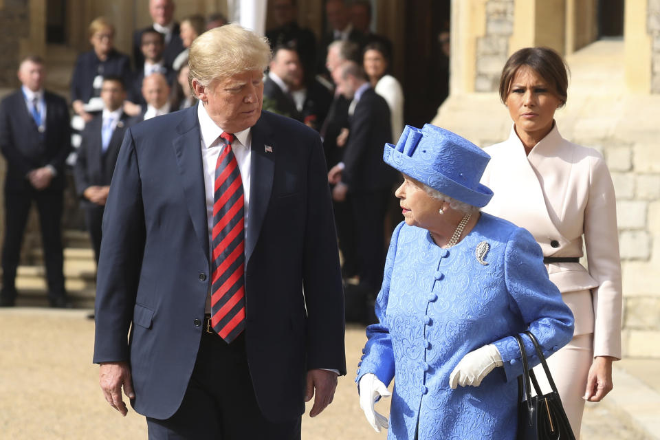 Britain's Queen Elizabeth II, right, US President of the United States, Donald Trump and first lady Melania walk from the Quadrangle after inspecting the Guard of Honour, during the president's visit to Windsor Castle, Friday, July 13, 2018 in Windsor, England. The monarch welcomed the American president in the courtyard of the royal castle. (Chris Jackson/Pool Photo via AP)
