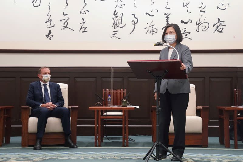 Taiwan's President Tsai Ing-wen speaks next to the former Australian Prime Minister Tony Abbott during their meeting in Taipei