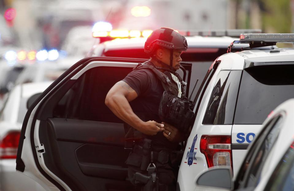 Police respond to reports of a shooting and subsequent lockdown at the U.S. Navy Yard in Washington July 2, 2015. Armed security personnel keep a watchful eye as police respond to reports of a shooting and subsequent lockdown at the U.S. Navy Yard in Washington July 2, 2015. (REUTERS/Jonathan Ernst)