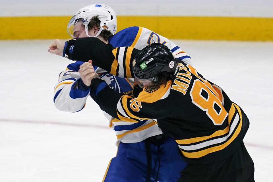 Boston Bruins defenseman Kevan Miller (86) follows through after landing a punch while fighting Buffalo Sabres right wing Tage Thompson during the second period of an NHL hockey game Tuesday, April 13, 2021, in Boston. (AP Photo/Charles Krupa)