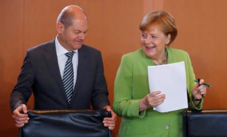 German Chancellor Angela Merkel and German Finance Minister Olaf Scholz arrive for the weekly cabinet meeting at the Chancellery in Berlin, Germany, June 20, 2018. REUTERS/Hannibal Hanschke