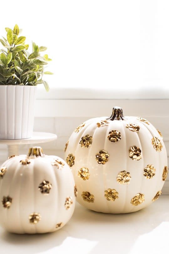 <p>These pumpkins favor glam over gore. By using a plastic pumpkin from the craft store, you can break these chic decor pieces out for years to come.</p><p>Get the tutorial at <a href="https://sugarandcloth.com/diy-sequin-polka-dot-pumpkins/" rel="nofollow noopener" target="_blank" data-ylk="slk:Sugar & Cloth;elm:context_link;itc:0;sec:content-canvas" class="link ">Sugar & Cloth</a>.</p>