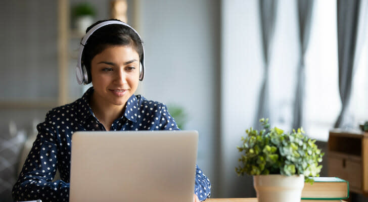 Image shows a young worker sitting at a desk and working on their laptop. SmartAsset used a variety of data sources to complete its latest study on the cities with the youngest workforces.