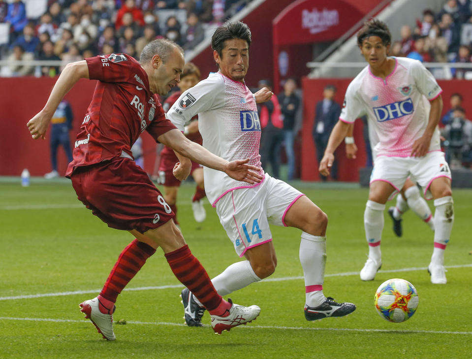 Vissel Kobe's Andres Iniesta, left, controls the ball against Sagan Tosu during a J-League soccer match in Kobe, western Japan, Saturday, March 2, 2019.(Kyodo News via AP)