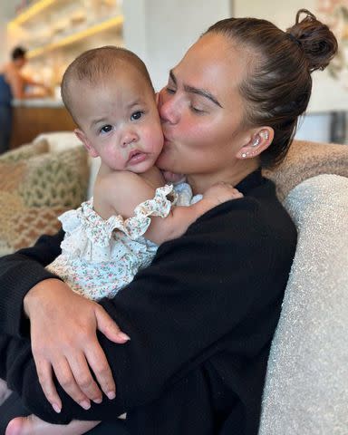 <p>chrissyteigen/Instagram</p> Chrissy Teigen cuddles Esti