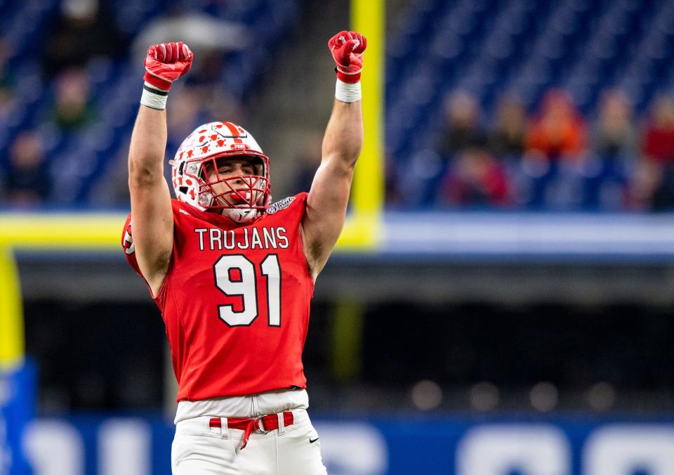 Center Grove High School senior Caden Curry (91) reacts after the team’s defense stops the Westfield High School offense during the first half of an IHSAA class 6A State Championship football game, Saturday, Nov. 27, 2021, at Lucas Oil Stadium