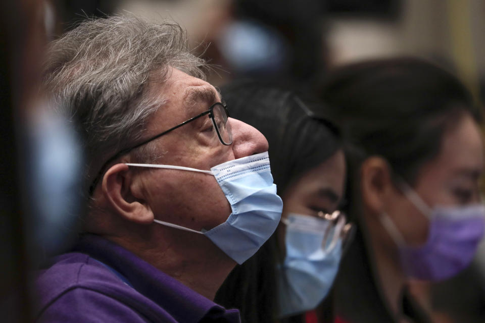 Journalists wearing a protective face mask to help curb the spread of the new coronavirus attend a press conference for the white paper on fighting COVID-19 China in action which is chaired by Xu Lin, vice head of the publicity department of the communist party, at the State Council Information Office in Beijing, Sunday, June 7, 2020. Senior Chinese health officials defended their country's response to the new coronavirus pandemic, saying they provided information in a timely and transparent manner. (AP Photo/Andy Wong)