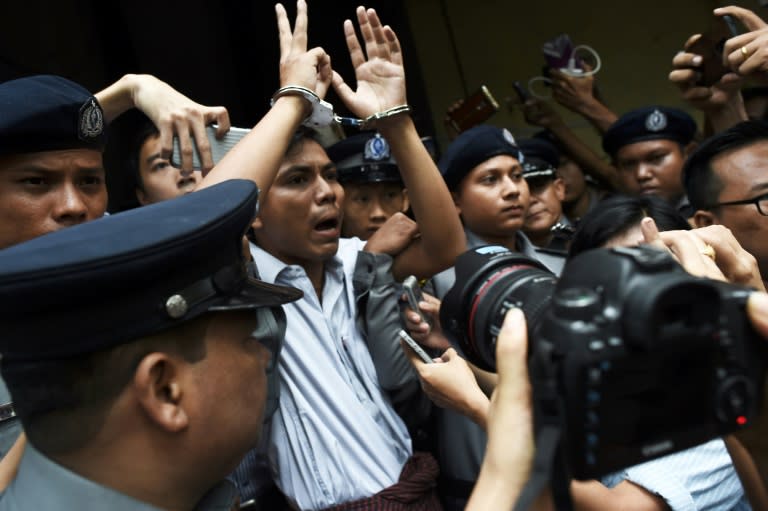 Myanmar journalist Kyaw Soe Oo is escorted by police after being sentenced in Yangon in September last year