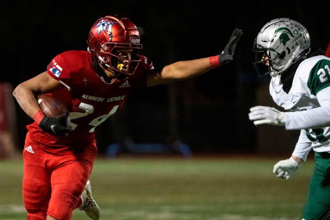 Kennedy Catholic running back Xe’Ree Alexander prepares to stiff arm Skyline Michael Roni on his way to the endzone for a rushing touchdown in the second quarter of a Class 4A state quarterfinal game on Friday, Nov. 18, 2022, at Highline Memorial Stadium in Burien, Wash. Pete Caster/Pete Caster / The News Tribune