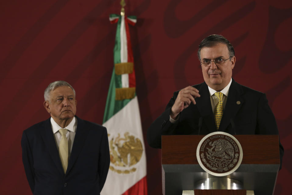 Mexican President Andres Manuel Lopez Obrador listens to Marcelo Ebrard, his Secretary of Foreign Affairs, during a daily morning press conference at the National Palace in Mexico City, Friday, Nov. 29, 2019.(AP Photo/Marco Ugarte)