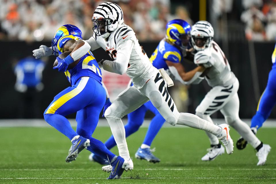 Safety Dax Hill (23) brings down running back Kyren Williams for a loss in the second quarter of the Bengals' 19-16 victory over the Rams Monday night. Williams managed only 38 yards rushing on 10 carries.