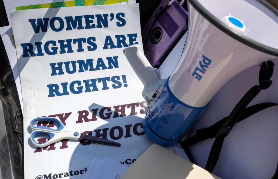 A sign that reads 'Women's Rights Are Human Rights!' sits next to a megaphone during an abortion rights protest at Hart Plaza in Detroit on Saturday, April 15, 2023.