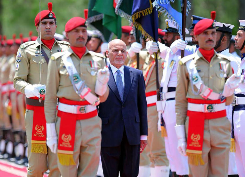 In this photo released by the Press Information Department, visiting Afghan President Ashraf Ghani reviews guard of honor in Islamabad, Pakistan, Thursday, June 27, 2019. Ghani has arrived on his first visit to Pakistan, in an attempt to forge a fresh relationship with Prime Minister Imran Khan's government and reach out to Islamabad for help in getting the Taliban to talk peace with Kabul.(Press Information Department,via AP)