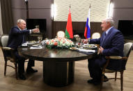 Russian President Vladimir Putin, left, and Belarusian President Alexander Lukashenko raise a toast during their meeting in the Black sea resort of Sochi, Russia, Saturday, Dec. 7, 2019. Leaders of Russia and Belarus sat down for talks Saturday on deepening ties between the two allies — a meeting that triggered a protest in the Belarusian capital. More than 1,000 opposition demonstrators rallied in Minsk to protest closer integration with Russia, which they fear could erode the post-Soviet independence of the nation of 10 million. (Mikhail Klimentyev, Sputnik, Kremlin Pool Photo via AP)