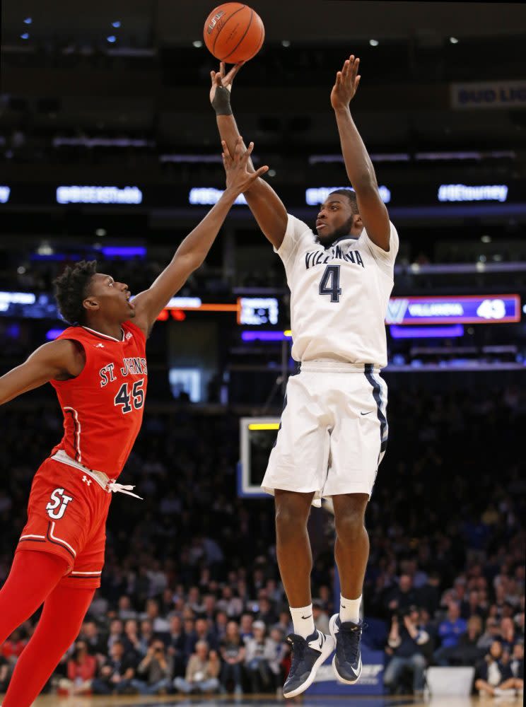 St. John’s forward Darien Williams (45) as Villanova forward Eric Paschall (4) shoots during the first half an NCAA college basketball game in the quarterfinals of the Big East Conference Tournament. (Associated Press)