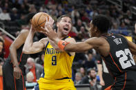 Detroit Pistons guard Jaden Ivey (23) reaches in on Indiana Pacers guard T.J. McConnell (9) during the first half of an NBA basketball game, Wednesday, March 20, 2024, in Detroit. (AP Photo/Carlos Osorio)