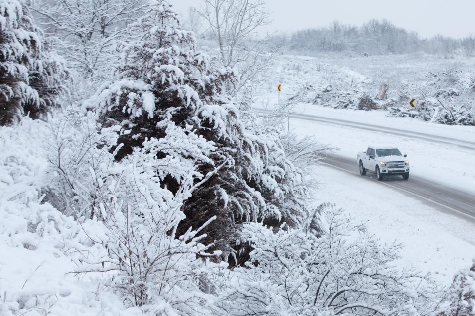 A truck rounds the corner of an on ramp from Highway 24 to southbound K-4 towards Topeka Tuesday as snow and freezing temperatures affect driving conditions.