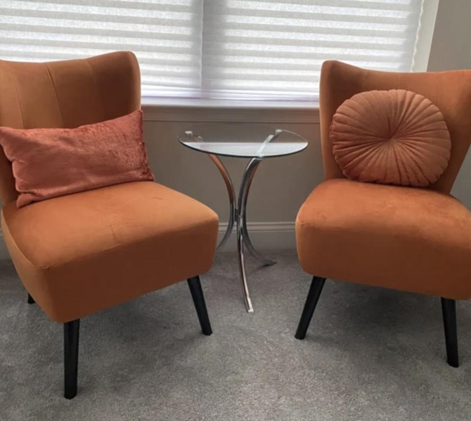 A reviewer's set of orange velvet accent chairs