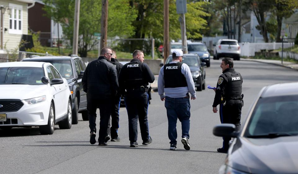 Police walk along Highland Boulevard in Keansburg Tuesday morning May 2, 2023, as an investigation of an earlier incident there continues.