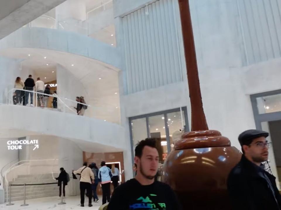 Hague gives viewers a sneak peek at the towering chocolate fountain inside the factory (Molly-Mae Hague/ YouTube)