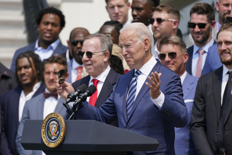 President Joe Biden, surrounded by members of the Tampa Bay Buccaneers, speaks during a ceremony on the South Lawn of the White House, in Washington, Tuesday, July 20, 2021, where the president honored the Super Bowl Champion Tampa Bay Buccaneers for their Super Bowl LV victory. (AP Photo/Manuel Balce Ceneta)