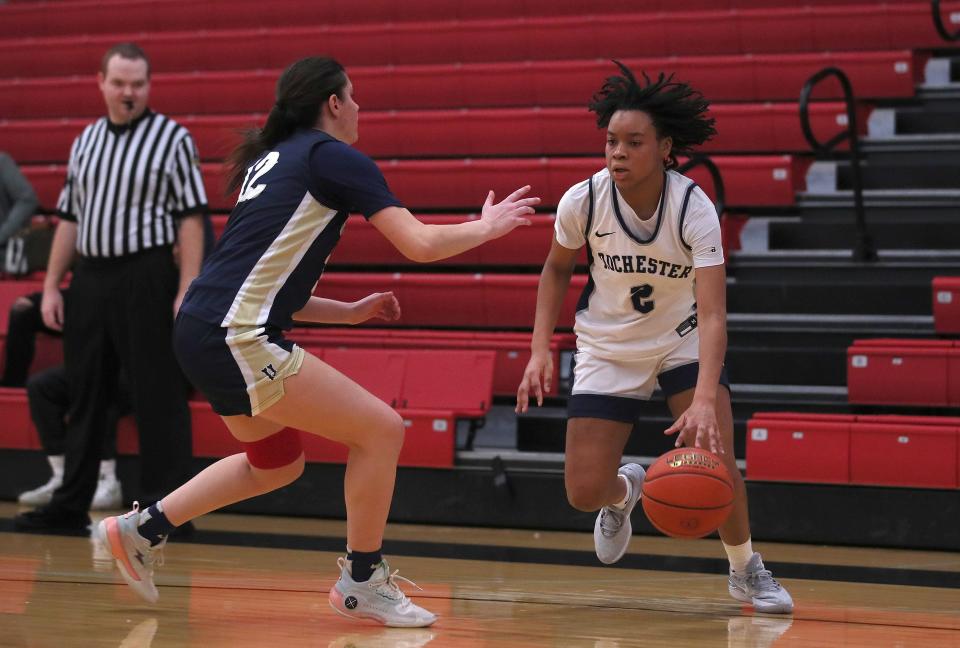 Rochester’s Marque Taylor (2) drives to the basket while being guarded by Hopewell’s Caylee Sundy (12) during the second half of the Win Palmer Memorial Classic Saturday afternoon at Sewickley Academy.