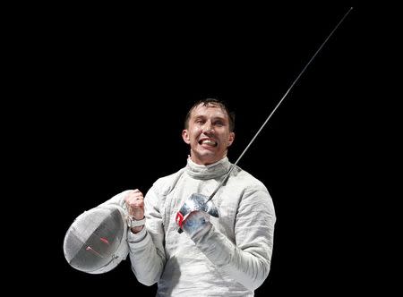 Russia's Alexey Yakimenko celebrates his victory over Daryl Homer of the U.S. in their men's sabre final at the World Fencing Championships in Moscow July 14, 2015. REUTERS/Grigory Dukor