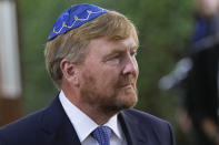 King Willem-Alexander arrives to unveil a new monument in the heart of Amsterdam's historic Jewish Quarter on Sunday, Sept. 19, 2021, honoring the 102,000 Dutch victims of the Holocaust. Designed by Polish-Jewish architect Daniel Libeskind, the memorial is made up of walls shaped to form four Hebrew letters spelling out a word that translates as "In Memory Of." The walls are built using bricks each of which is inscribed with the name of one of the 102,000 Jews, Roma and Sinti who were murdered in Nazi concentration camps during World War II or who died on their way to the camps. (AP Photo/Peter Dejong)