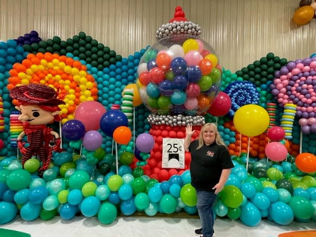 Dena Atchley stands next to a balloon gumball machine that she helped build at the Big Balloon Build in Vincennes, Indiana in April. The Big Balloon Build is an international balloon art festival. Its second time in the United States will be in Kansas City, where Atchley is serving as a detail lead, helping put together the finishing touches. The Big Balloon Build in Kansas City is Dec. 2-4.