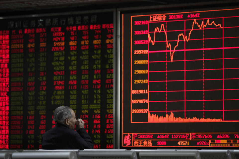 An investor monitors share prices at a brokerage house in Beijing, Wednesday, March 27, 2019. Shares were mixed in Asia early Wednesday after U.S. stocks finished broadly higher on Wall Street, erasing modest losses from a day earlier. (AP Photo/Andy Wong)