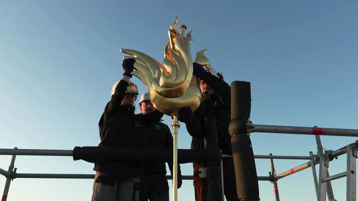the new golden rooster containing relics being installed atop the spire of Notre Dame cathedral (Gaspard Flamand / AFP via Getty Images)