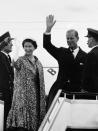 FILE - In this file photo dated June 18, 1959, Prince Philip waves as he and Queen Elizabeth II stand at top of plane ramp at London Airport, prior to their departure by jet airliner for 45-day tour of Canada. Prince Philip who died Friday April 9, 2021, aged 99, lived through a tumultuous century of war and upheavals, but he helped forge a period of stability for the British monarchy under his wife, Queen Elizabeth II. Philip helped create the Commonwealth of nations, with the queen at its head, in an attempt to bind Britain and its former colonies together on a more equal footing. (AP Photo, FILE)