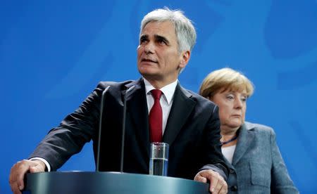 File photo of Austrian Chancellor Werner Faymann and German Chancellor Angela Merkel (R) reacting during a news conference at the Chancellery in Berlin, Germany September 15, 2015. REUTERS/Hannibal Hanschke/Files