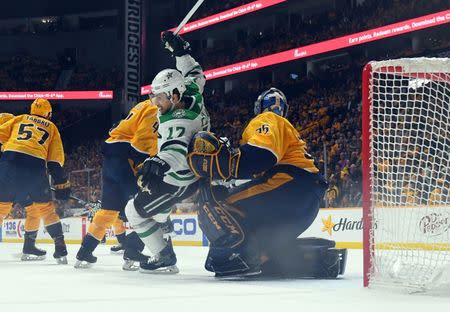 Apr 20, 2019; Nashville, TN, USA; Dallas Stars center Andrew Cogliano (17) is knocked down in front of Nashville Predators goaltender Pekka Rinne (35) during the first period in game five of the first round of the 2019 Stanley Cup Playoffs at Bridgestone Arena. Mandatory Credit: Christopher Hanewinckel-USA TODAY Sports
