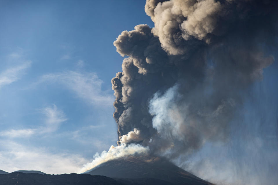 An ash column rises during an eruption of Mt. Etna, Europe's largest active volcano, as seen from the Bove Valley of Etna Park, on the eastern slope of Mt. Etna, in Sicily, southern Italy, Sunday, July 4, 2021. Since Feb. 16, 2021, Mt. Etna has begun a series of eruptive episodes. (AP Photo/Salvatore Allegra)