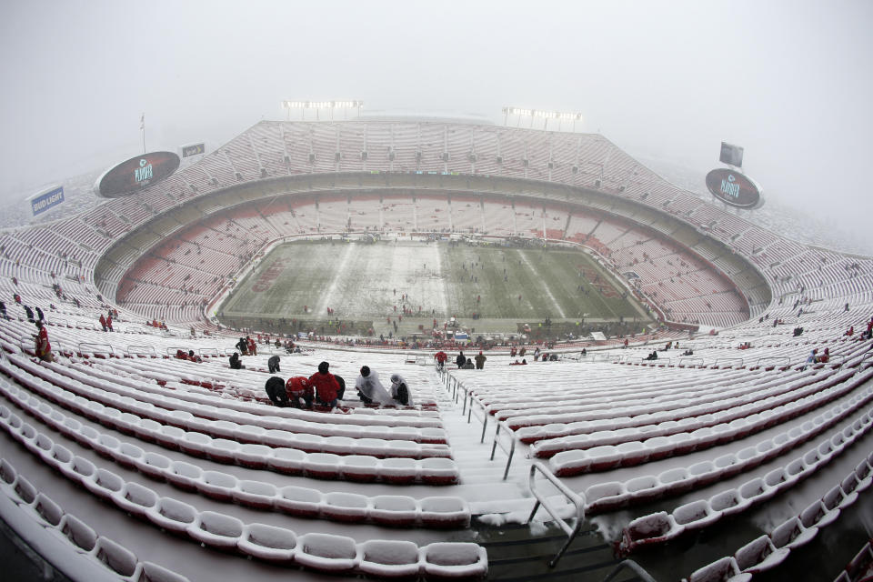 Fans arrive at a snow covered Arrowhead Stadium before an NFL divisional football playoff game between the Kansas City Chiefs and the Indianapolis Colts, in Kansas City, Mo., Saturday, Jan. 12, 2019. (AP Photo/Charlie Riedel)