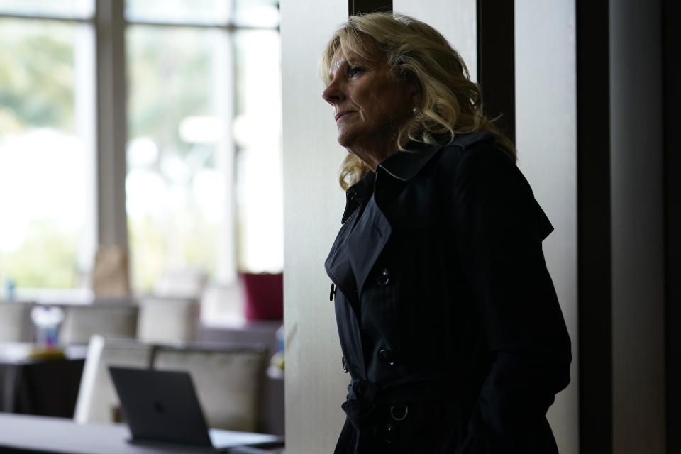 FILE - In this July 1, 2021, file photo first lady Jill Biden listens as President Joe Biden speaks in Miami Beach, Fla., about the condo tower that collapsed in Surfside, Fla., last week. (AP Photo/Susan Walsh, File)