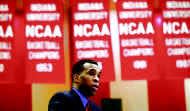 In this file photo from 2000, NCAA championship banners serve as a backdrop for Mike Davis as he speaks during a news conference at Assembly Hall following his appointment as the head coach of the Indiana men's basketball team.