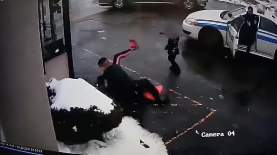 A screenshot from security camera footage shows the moment an unidentified Black mother was tackled during an interaction with police officers in Rochester, New York on Feb. 22, 2021.